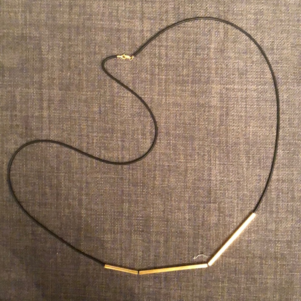Long, black cord necklace with gold